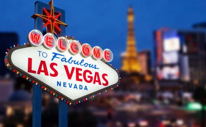 LAS VEGAS - MAY 12 : Welcome to fabulous Las Vegas neon sign with Las Vegas strip road background View of the strip on May 12, 2015